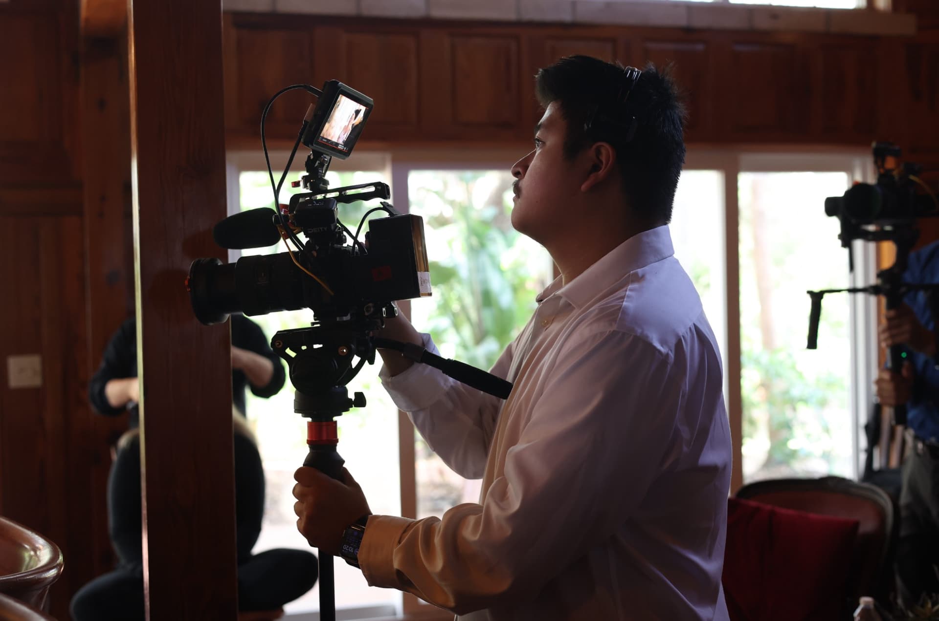 A Skytona cinematographer operating a camera on a wedding day