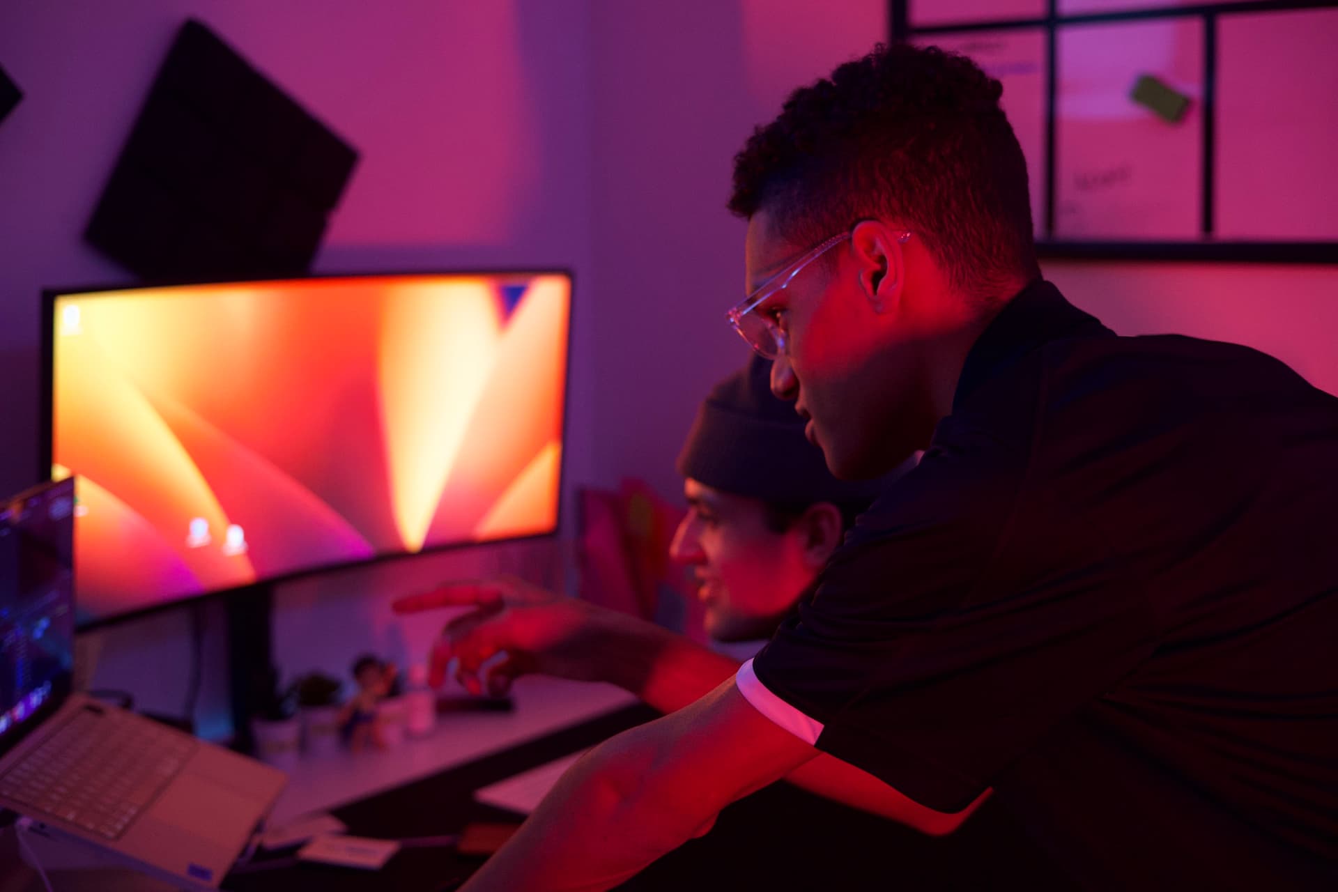 Two editors reviewing a timeline together in the edit bay
