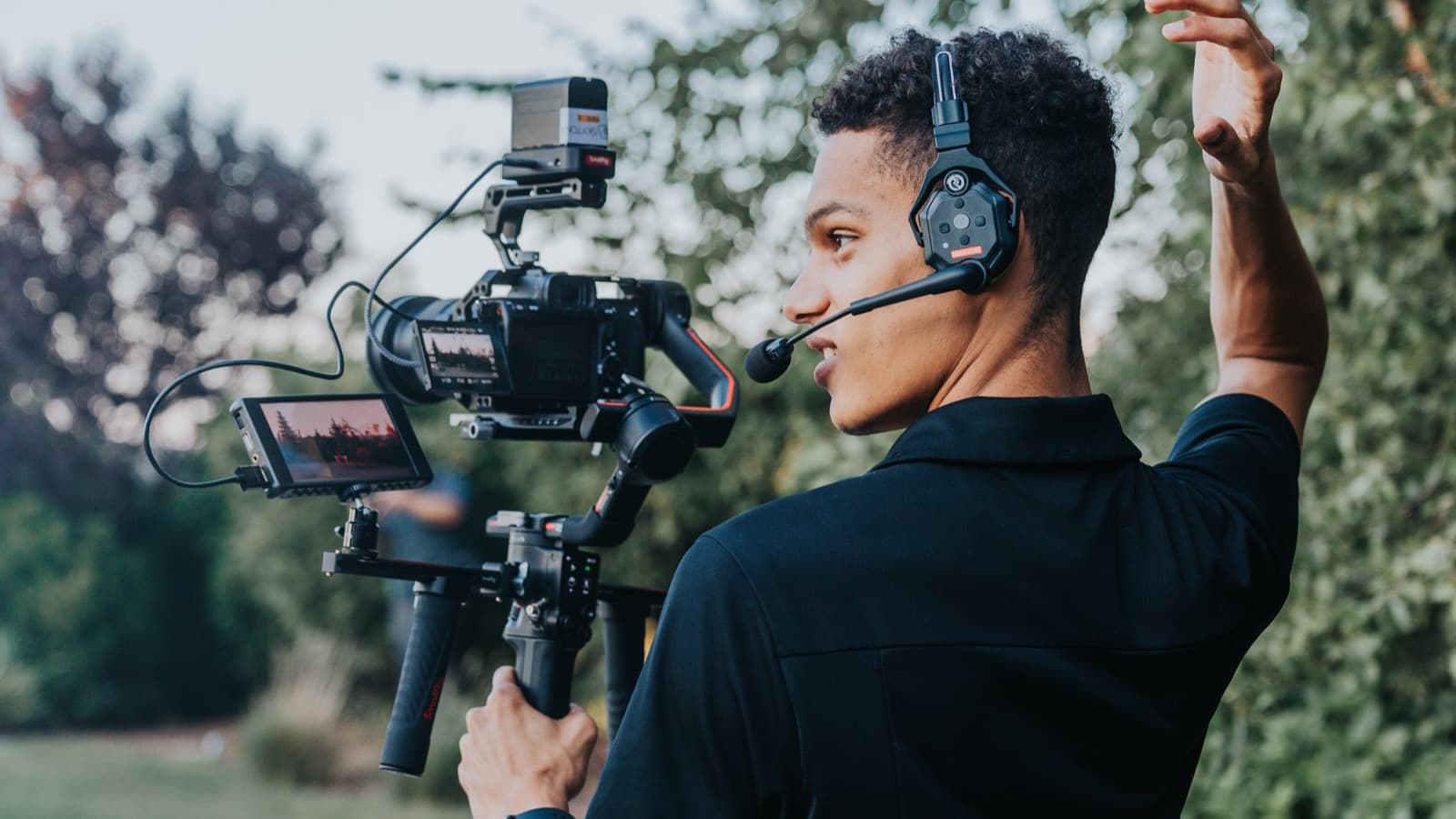A Skytona filmmaker with a gimbal rig directing during golden hour.