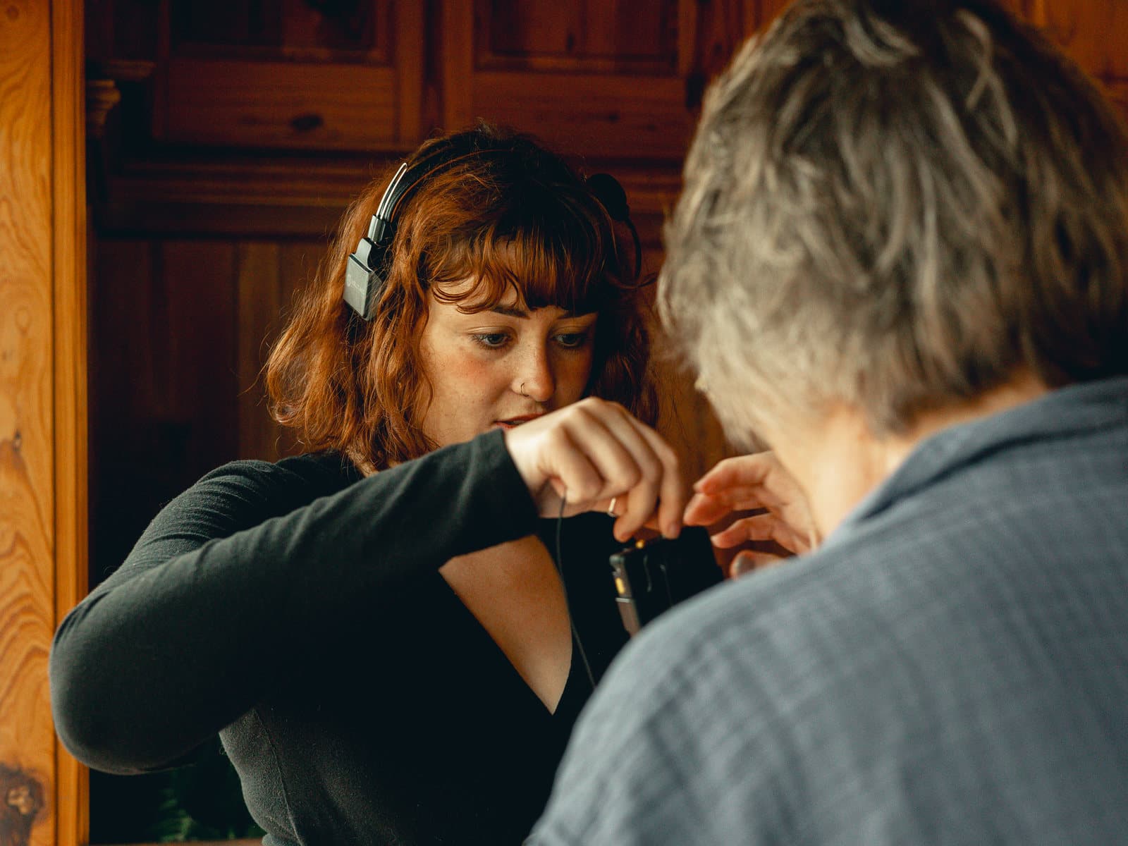 A Skytona team member clipping a lavalier microphone before filming.