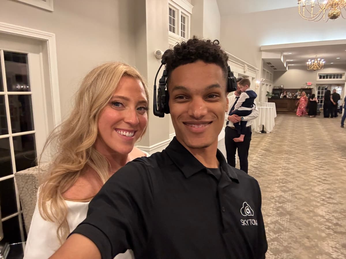 Skytona team member with a couple at a wedding