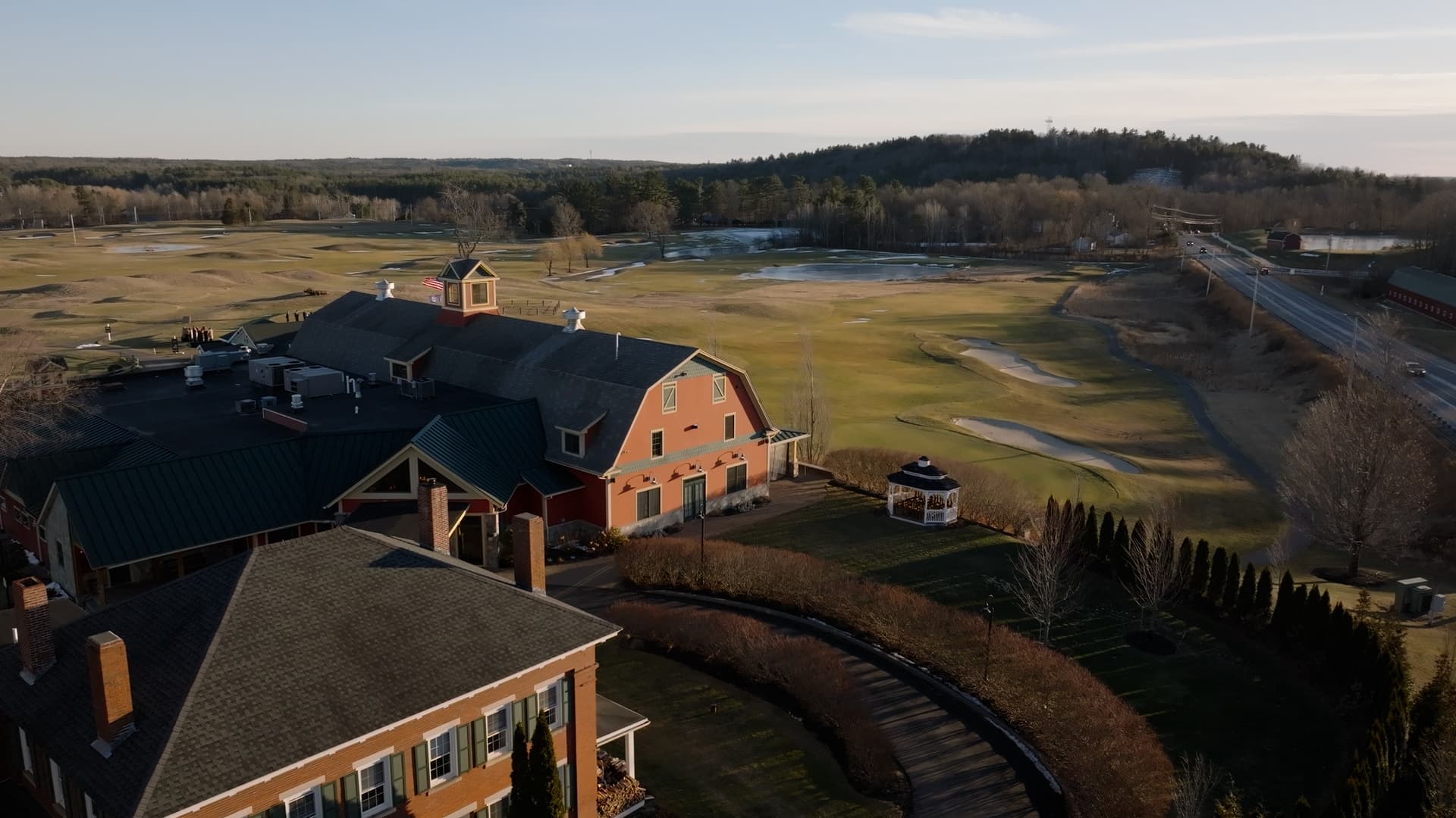 A New England barn wedding venue at golden hour, by Skytona
